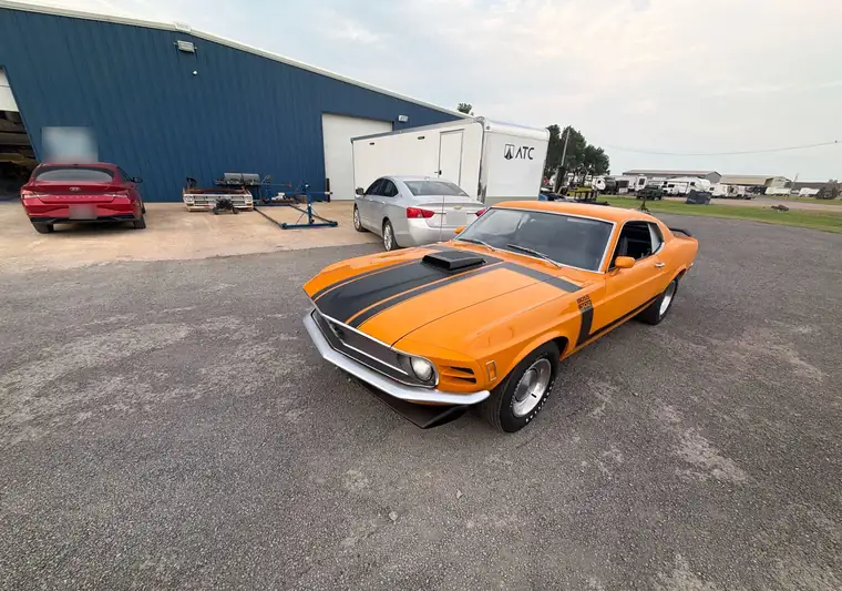 Orange 1970 Ford Mustang Fastback with black stripes at pickup in Blytheville, Arkansas
