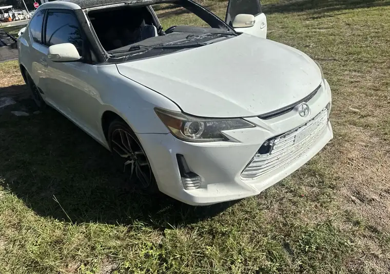 White 2014 Scion tC on the ground at delivery in Long Beach, Mississippi