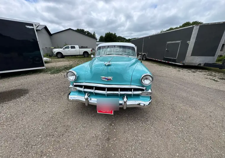 Front view of the same Bel Air with enclosed trailers parked behind it