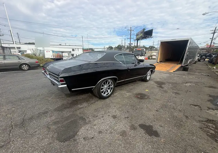 The same Chevelle beside the enclosed trailer with its ramp down at delivery in Newark, New Jersey