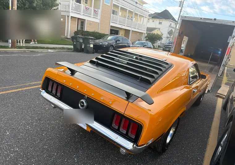 The same Mustang Fastback beside an enclosed trailer with the door open at delivery in Wildwood, New Jersey