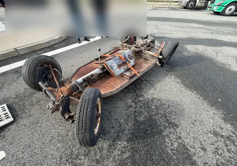 The same Volkswagen Beetle chassis on the pavement at delivery in New Jersey