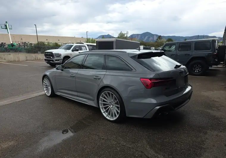 Gray 2026 Audi RS 6 Avant wagon at pickup in Boulder, Colorado, with the Flatirons in the background