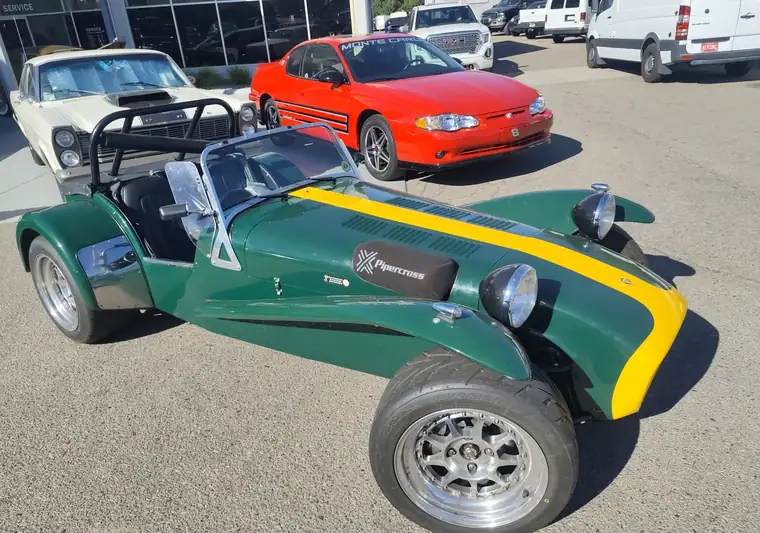 Green and yellow 1973 Caterham Seven roadster at pickup in Greeley, Colorado
