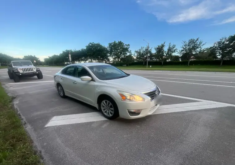 The same Nissan Altima on a road at delivery in Boca Raton, Florida