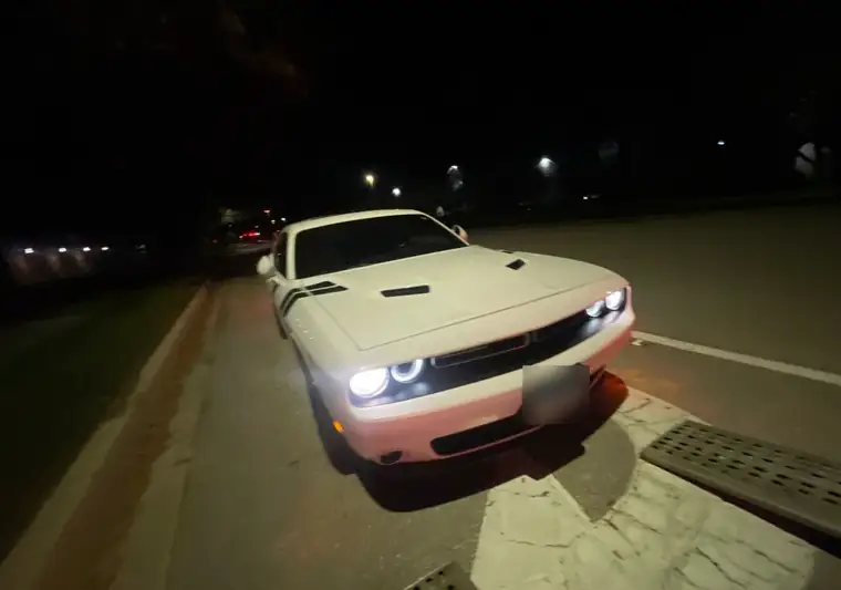 The same Dodge Challenger on a street at night at delivery in Naples, Florida