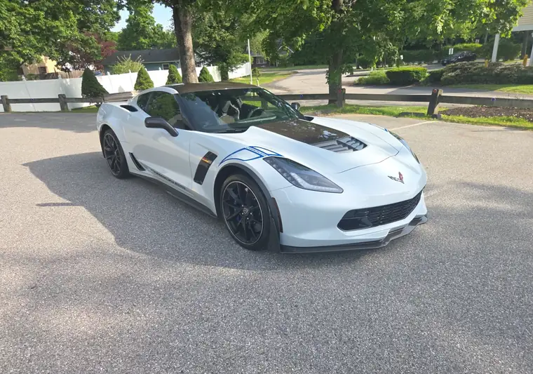 White 2018 Chevrolet Corvette Grand Sport with a carbon fiber hood at pickup in Torrington, Connecticut