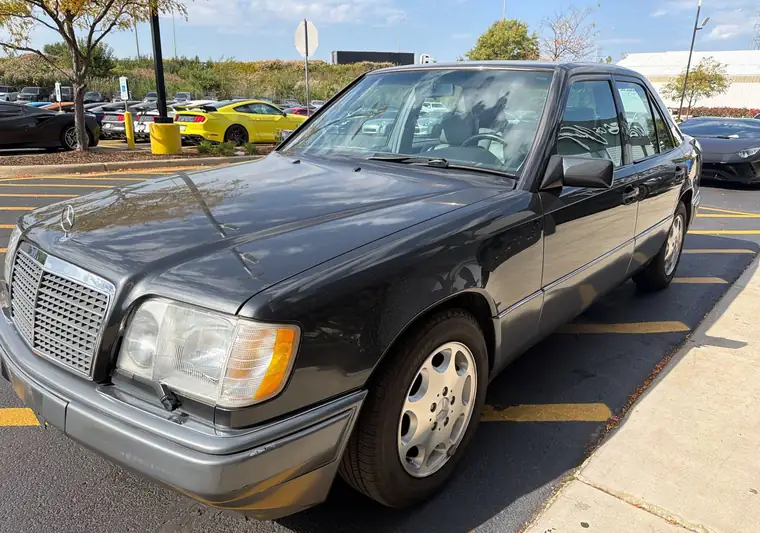 Black 1995 Mercedes-Benz E-Class sedan in a dealership parking lot at pickup in Joliet, Illinois