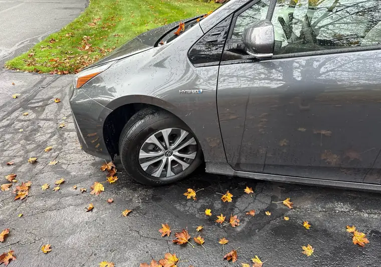 Gray 2019 Toyota Prius hybrid parked on a wet driveway at pickup in White River Junction, Vermont