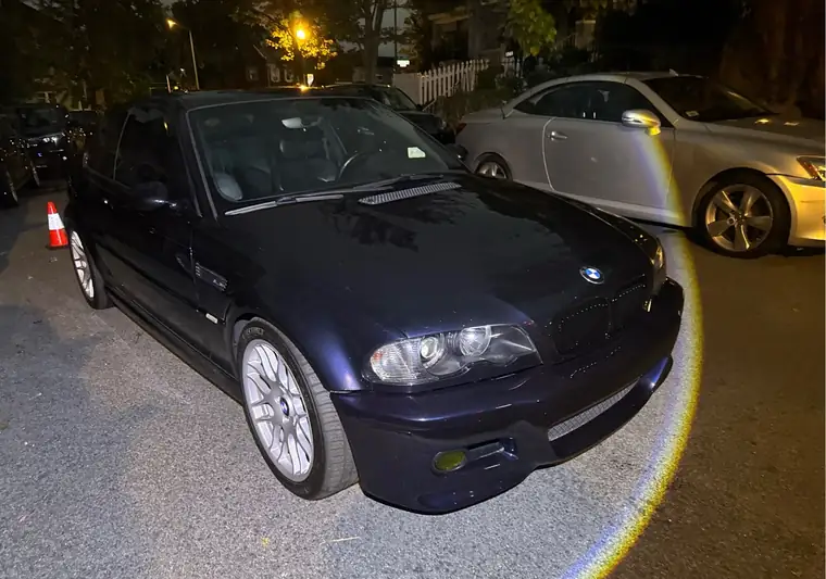 The same BMW M3 parked on a street at night at delivery in Washington, DC