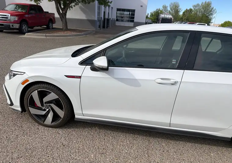 White 2023 Volkswagen Golf GTI in a dealership lot in Santa Fe, New Mexico
