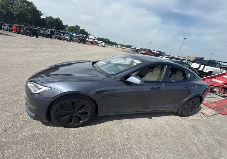 Gray 2021 Tesla Model S at pickup in an auction lot in Ocoee, Florida