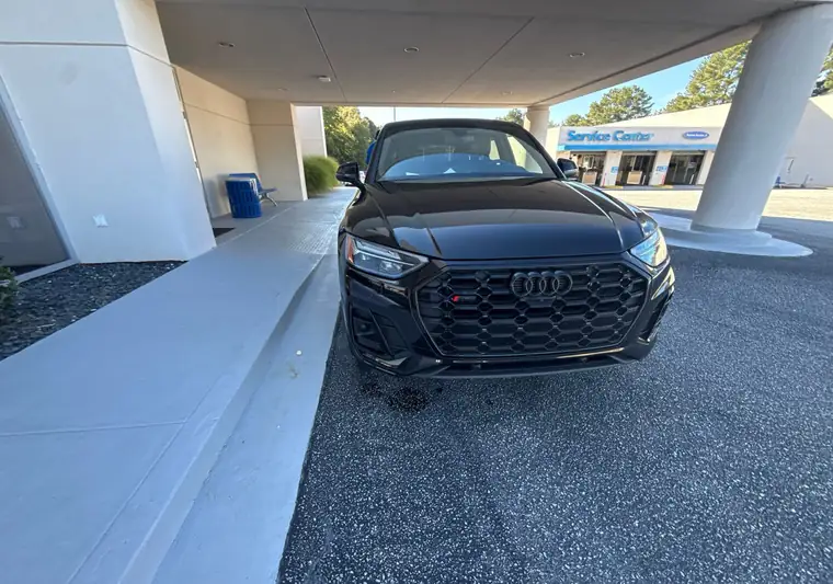 Black 2023 Audi Q5 Sportback under the awning of a dealership in Snellville, Georgia