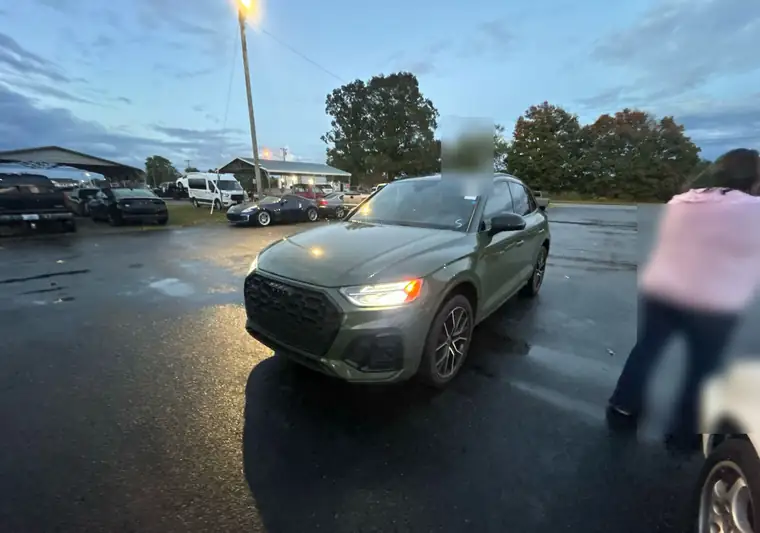 The same Audi SQ5 in a wet parking lot at dusk at delivery in Jamestown, Kentucky