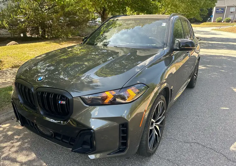 Dark green 2024 BMW X5 at pickup at a dealership in Athens, Georgia