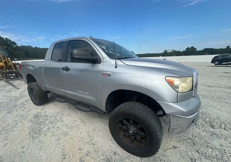 Silver 2011 Toyota Tundra double cab on a gravel lot at pickup in Byron, Georgia