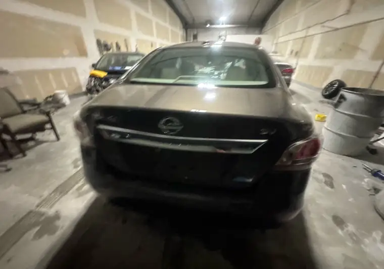 The same Nissan Altima inside a shop at delivery in Johnston, Iowa