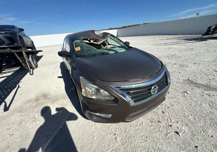 Brown 2015 Nissan Altima with a crushed roof at a salvage yard near East St. Louis, Illinois