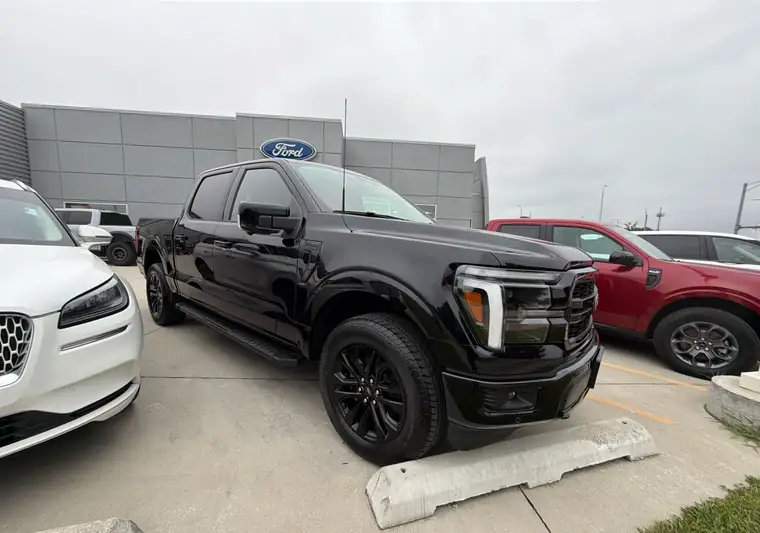Black 2026 Ford F-150 in front of a Ford dealership in Effingham, Illinois