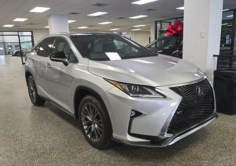 Silver 2019 Lexus RX 450h F Sport in a dealership showroom in Chicago, Illinois
