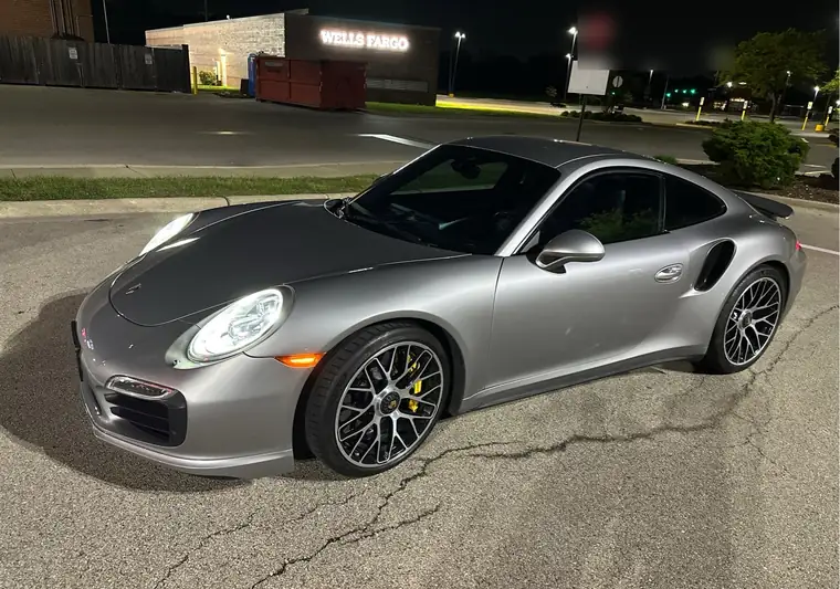 Silver 2015 Porsche 911 Turbo S at night in a parking lot in Elmhurst, Illinois
