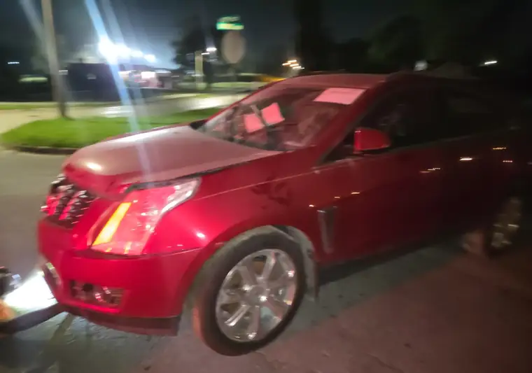 The same Cadillac SRX on a street at night at delivery in Kansas City, Kansas
