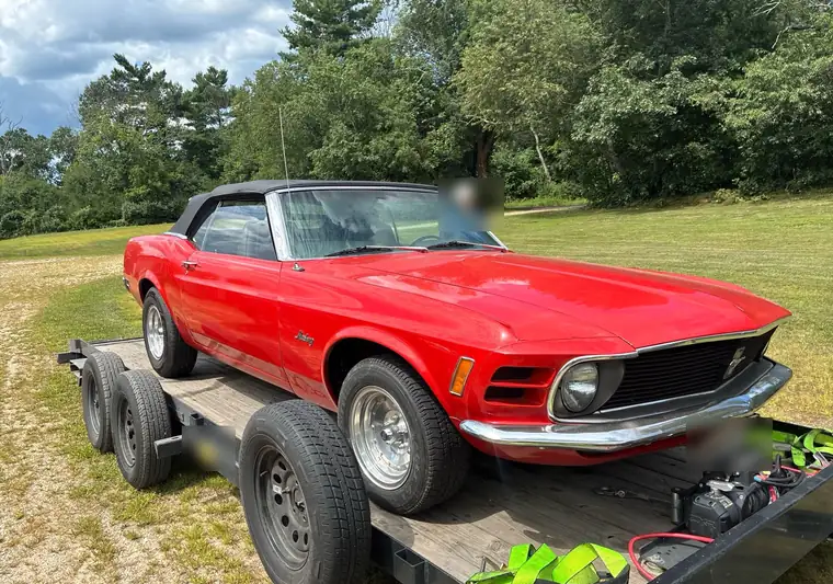 The same Mustang convertible on an open car hauler at delivery in Putnam, Connecticut