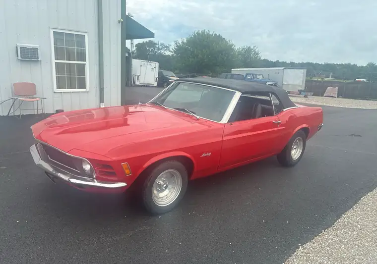 Red 1970 Ford Mustang convertible with a black top in a driveway in Knightstown, Indiana