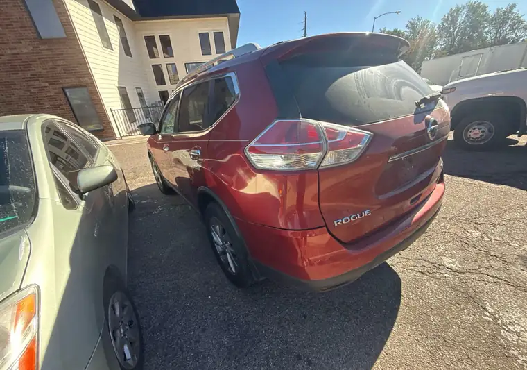 The same Nissan Rogue in a parking lot at delivery in Aurora, Colorado