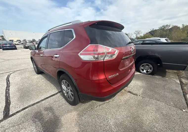 Red 2015 Nissan Rogue seen from the rear at pickup in Merrillville, Indiana