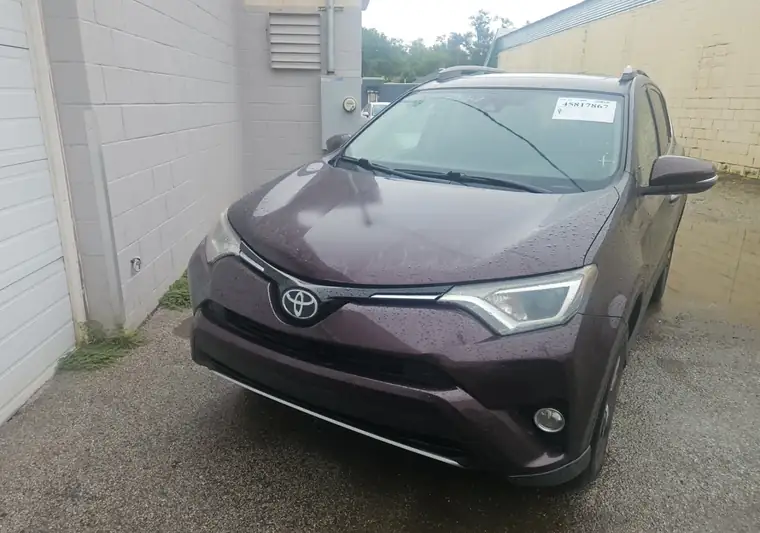 The same Toyota RAV4 beside a building at delivery in Omaha, Nebraska