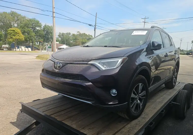 Dark purple 2017 Toyota RAV4 on a car hauler at an IAA yard in South Bend, Indiana