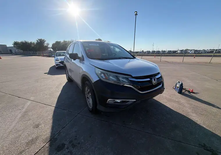 Silver 2015 Honda CR-V on an asphalt auction lot at pickup in Hutchins, Texas