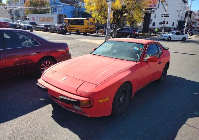 The same Porsche 944 parked on a city street at delivery in Newark, New Jersey