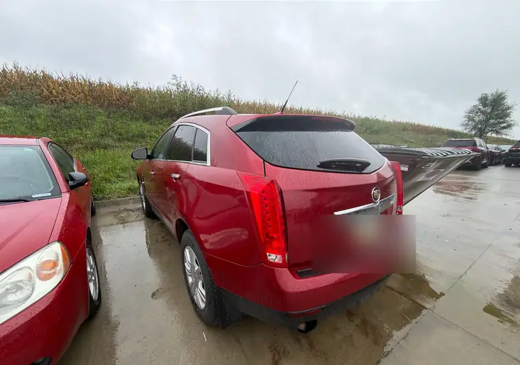 Red 2012 Cadillac SRX seen from the rear at pickup in De Soto, Iowa