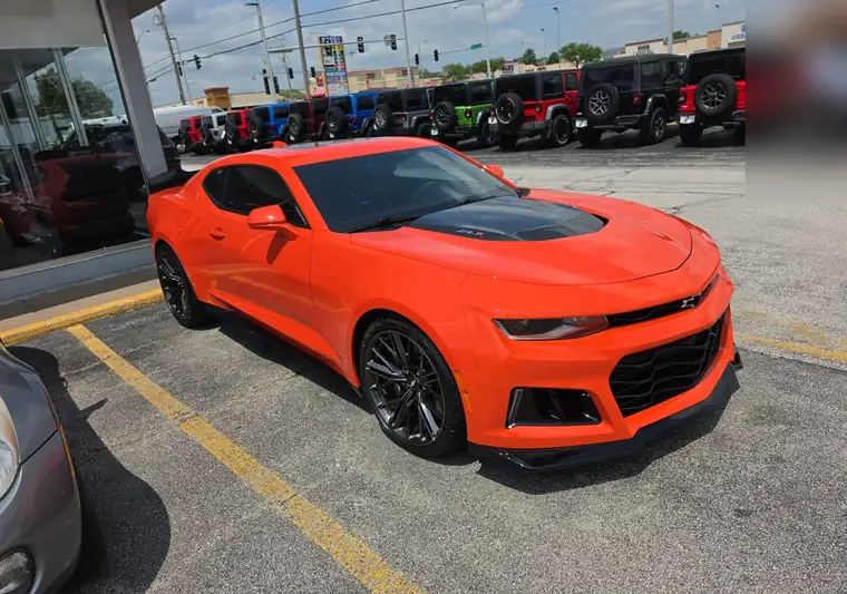 Orange 2019 Chevrolet Camaro in a dealership lot in Davenport, Iowa