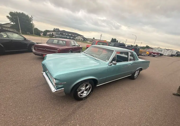 Teal 1964 Pontiac LeMans in a parking lot in Spirit Lake, Iowa