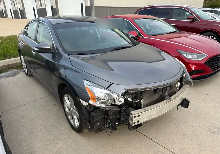 The same Nissan Altima in a parking lot at delivery in De Soto, Iowa