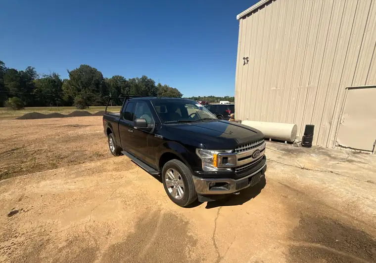 The same F-150 on a dirt lot at delivery in Clinton, Mississippi