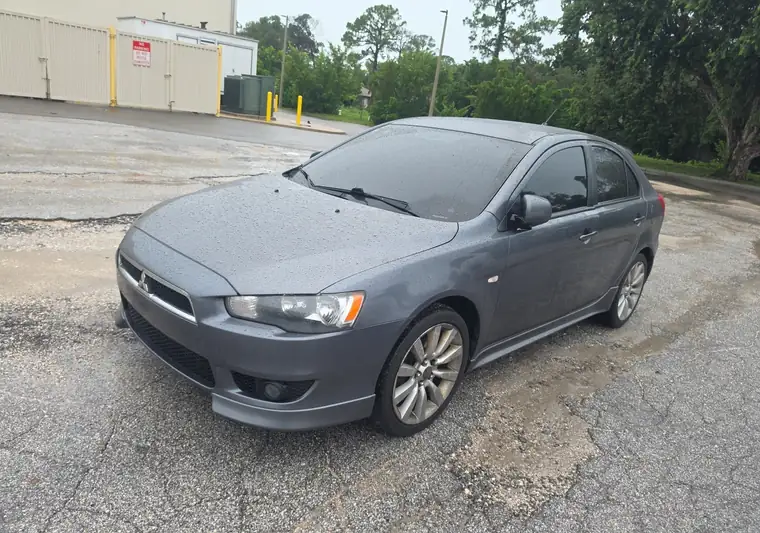 The same Mitsubishi Lancer on a wet lot at delivery in Sarasota, Florida