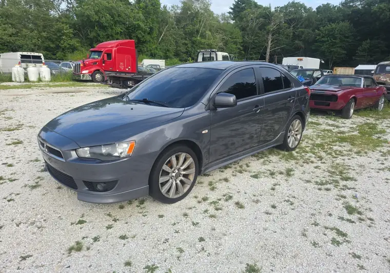 Gray 2014 Mitsubishi Lancer hatchback on a gravel lot in Westport, Massachusetts