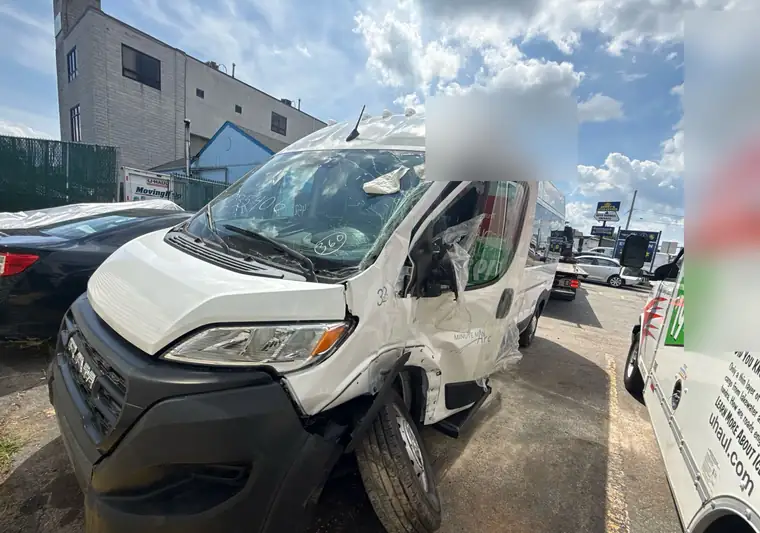 The same white Ram ProMaster with a crushed front end at delivery in Brockton, Massachusetts