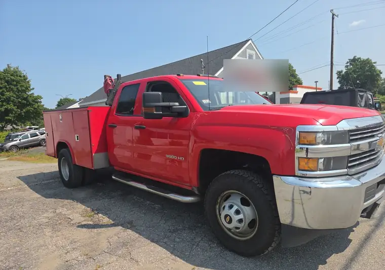 Red 2017 Chevrolet Silverado 3500HD utility truck on a lot in Seekonk, Massachusetts