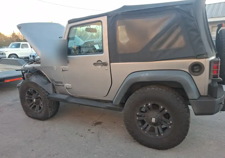 The same Wrangler with its hood open at delivery in Winchester, Virginia