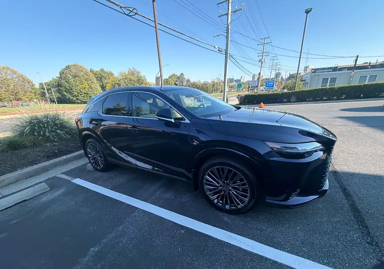 Dark blue 2025 Lexus RX 450h in a parking lot at pickup in Towson, Maryland
