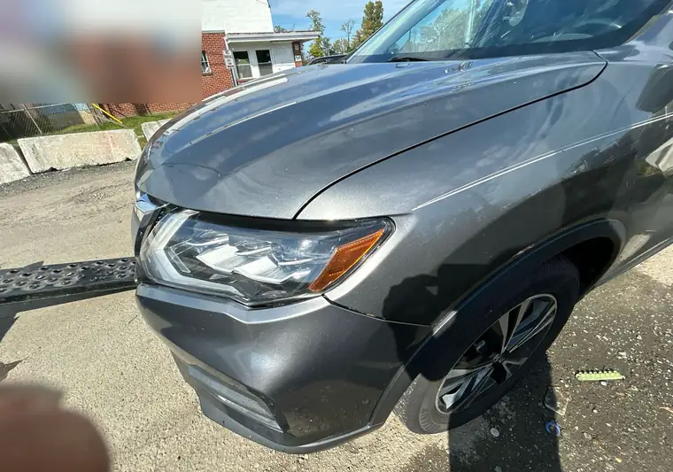 The same Nissan Rogue loaded on a ramp at delivery in Lanham, Maryland