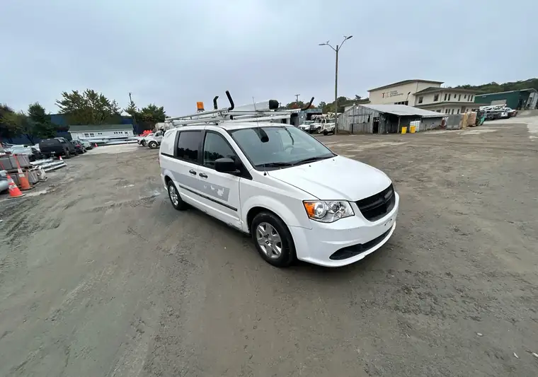 White 2013 Ram C/V cargo van with a roof rack on a gravel lot in Harmans, Maryland