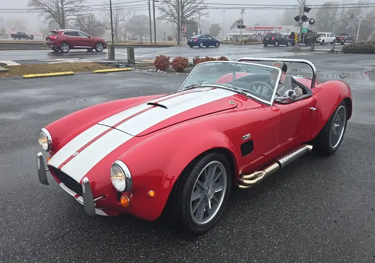 Red 1966 Shelby Cobra with white stripes in a parking lot in Fruitland, Maryland