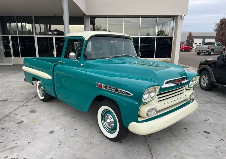 Teal and cream 1959 Chevrolet Apache pickup outside a building in Greeley, Colorado
