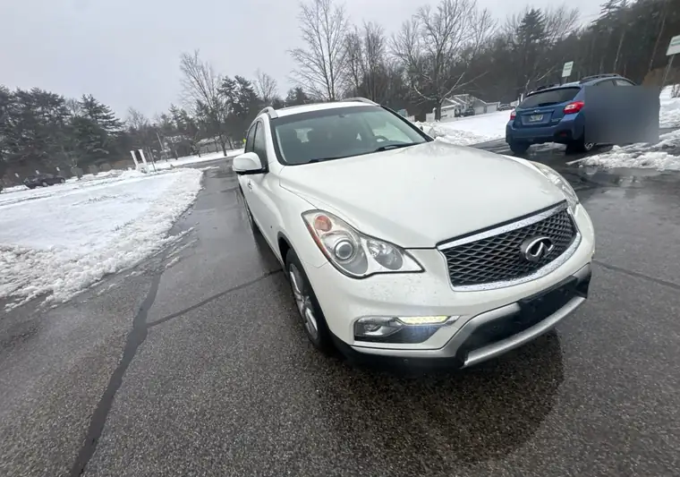 The same Infiniti QX50 in a snowy parking lot at delivery in Westbrook, Maine